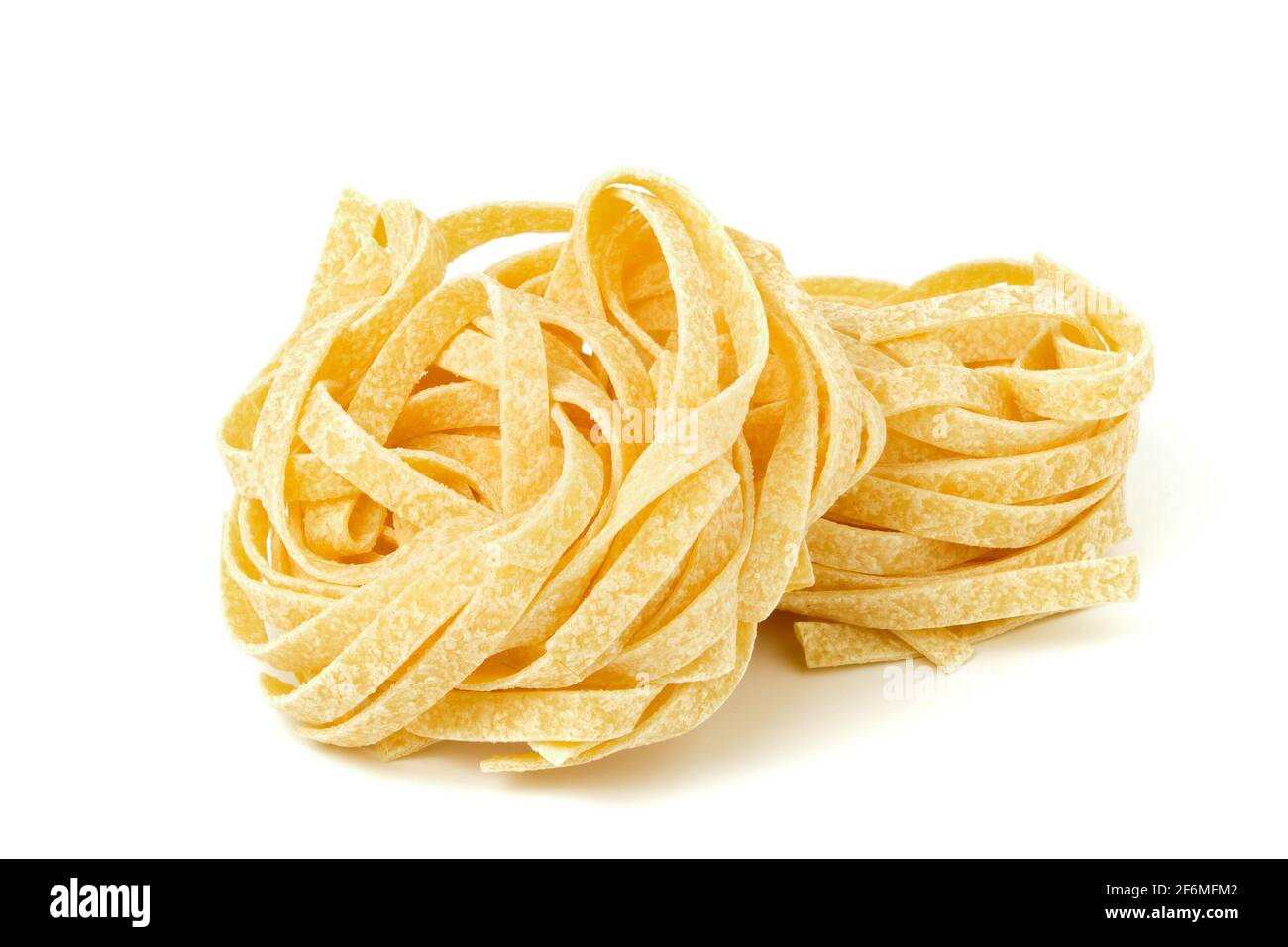 Uncooked tagliatelle pasta isolated on white Stock Photo