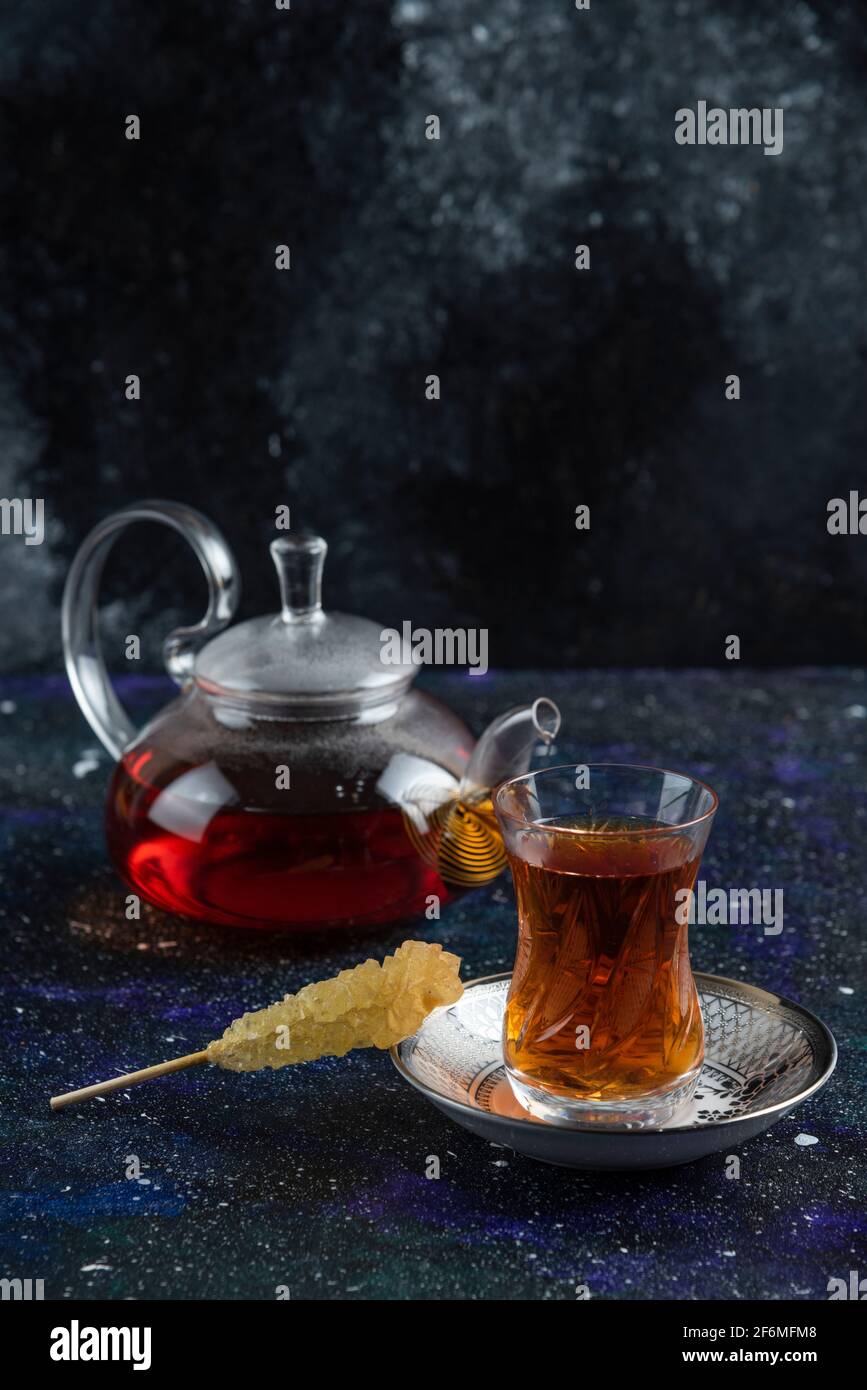 Vertical photo of Teapot and glass of tea Stock Photo