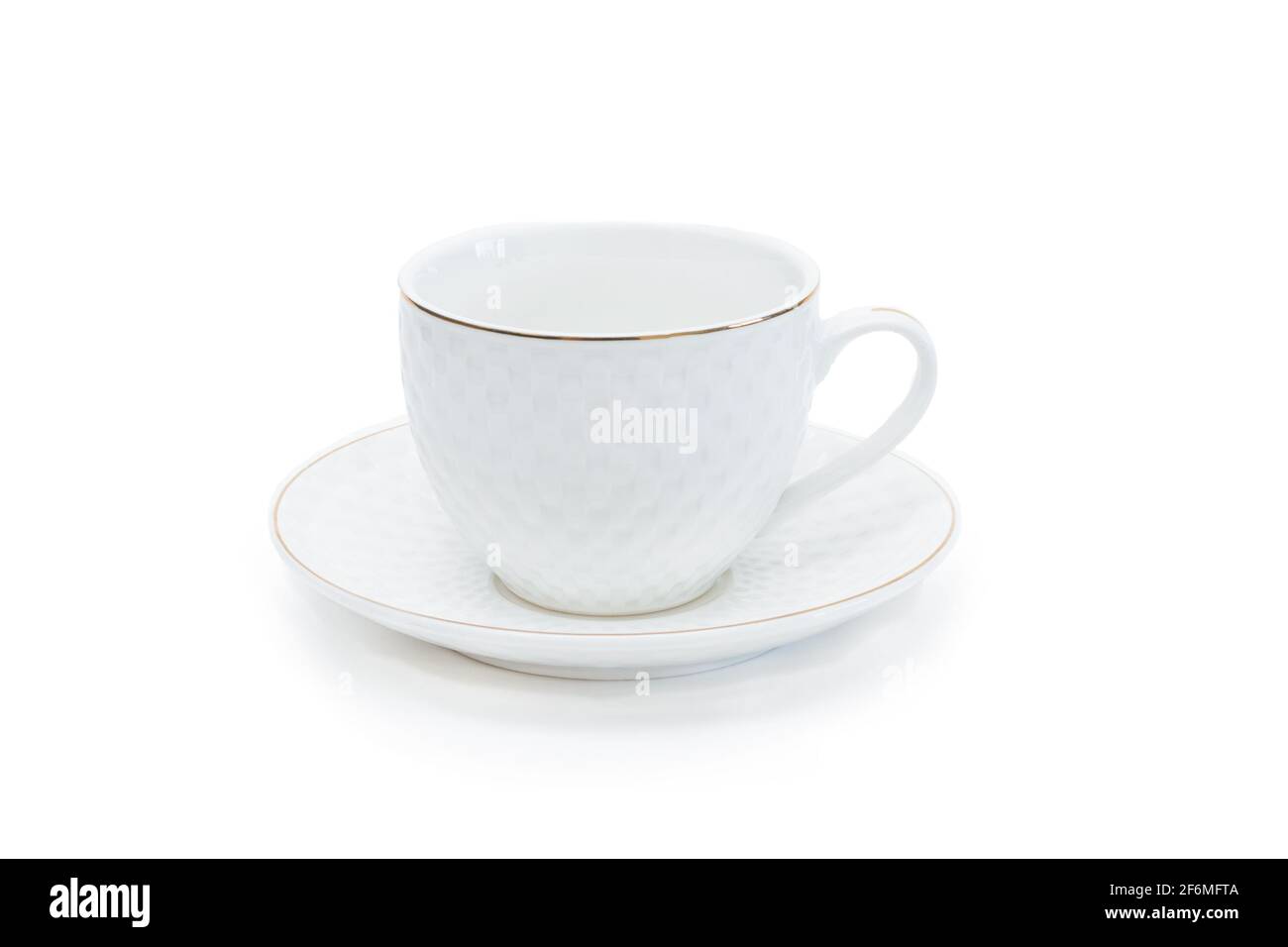 White porcelain tea cup with saucer and gold border. Isolated on white