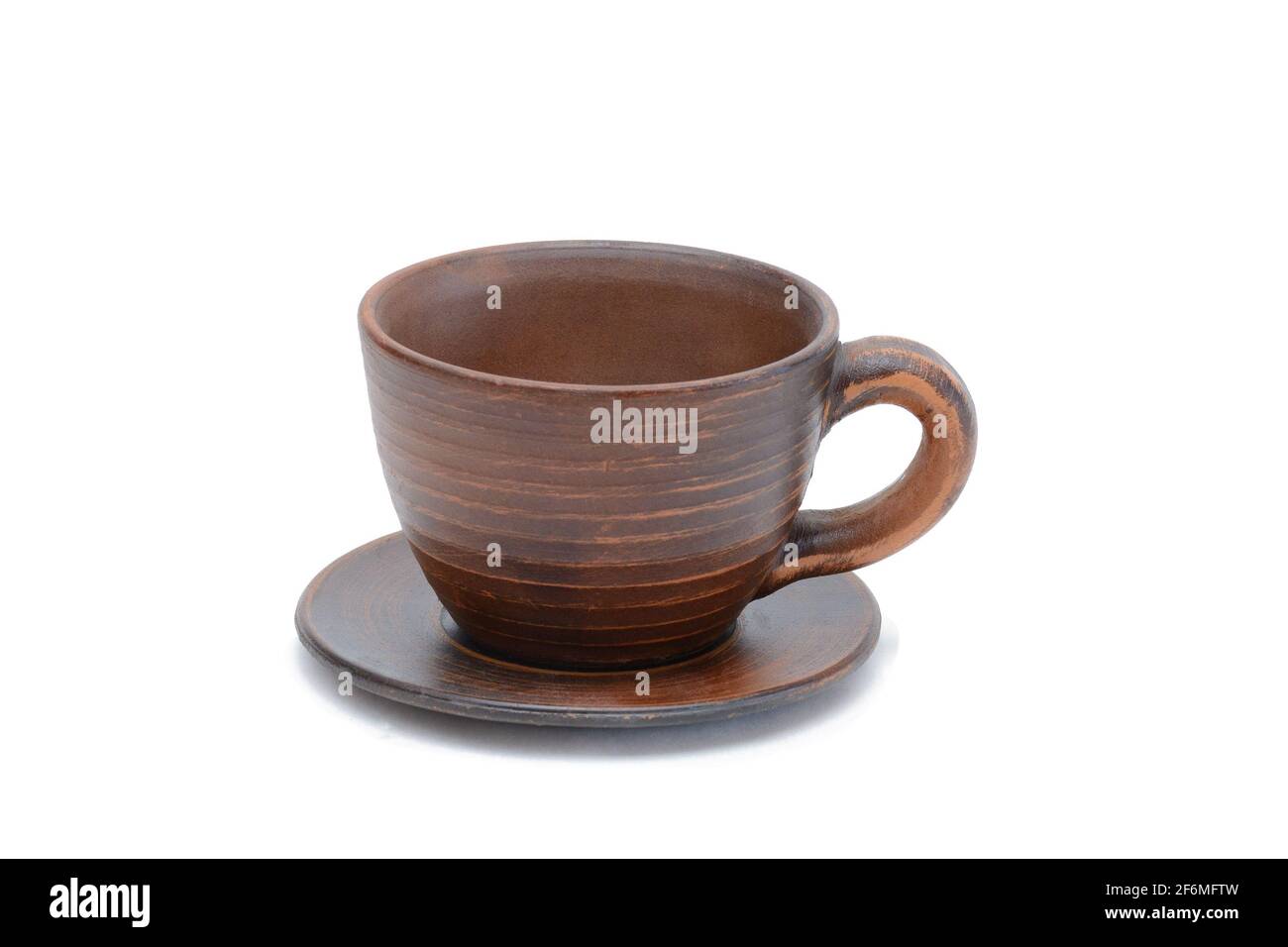 Handmade red clay cup and saucer. Isolated on white background Stock