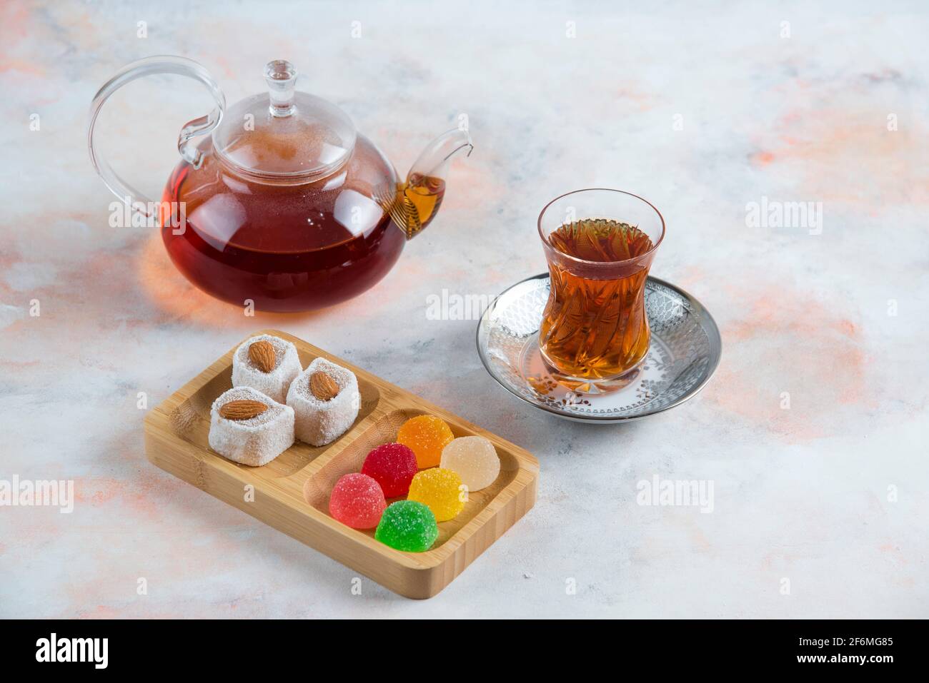 Top view of Tea pot glass tea and candies on white background Stock Photo