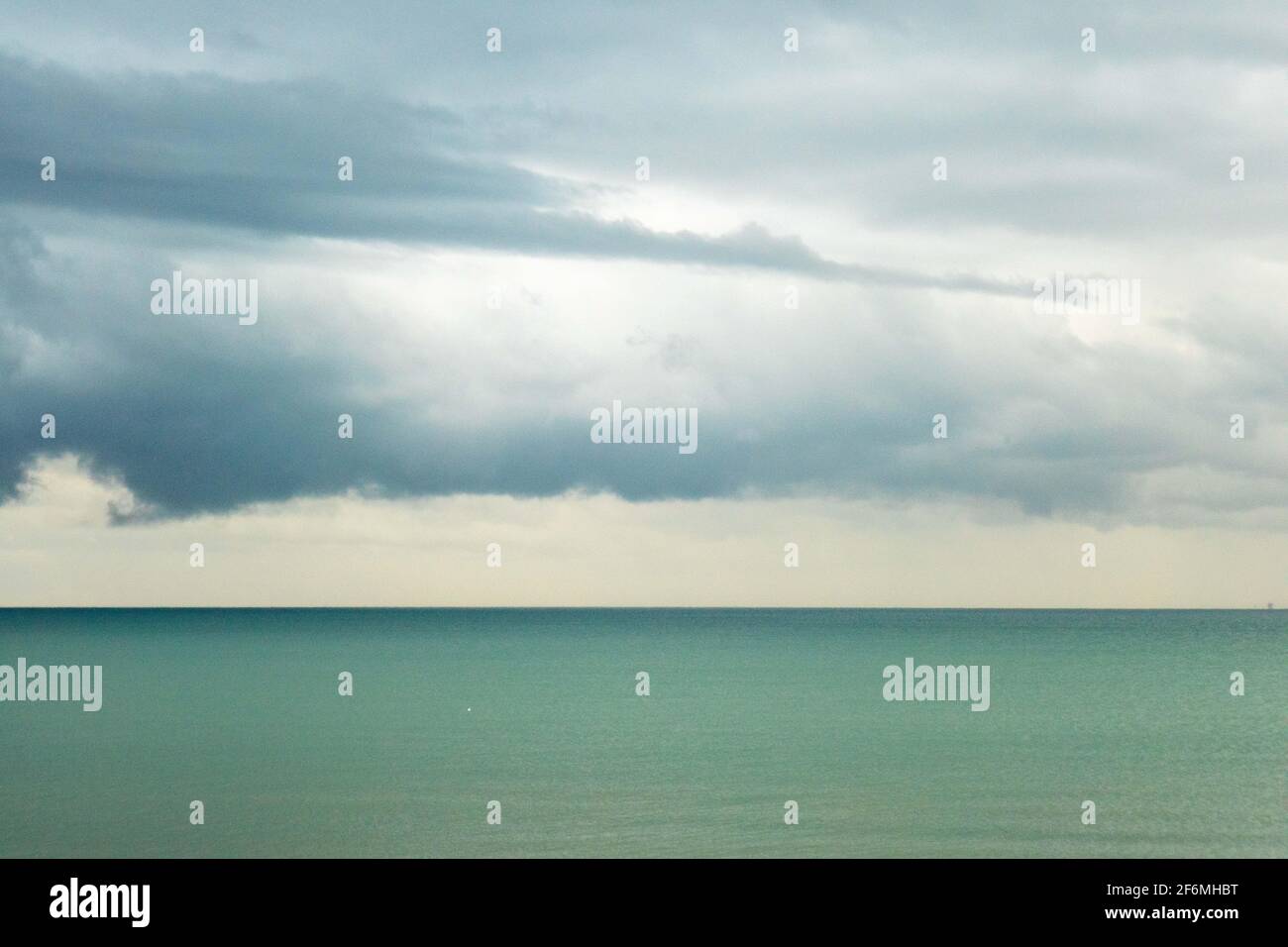 Cloudy sky over a beach hi-res stock photography and images - Alamy