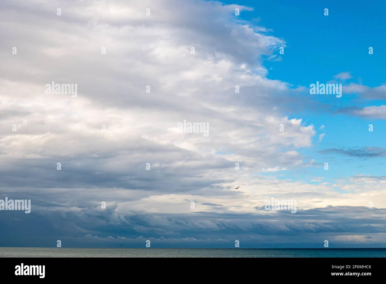 Cloudy sky over a beach hi-res stock photography and images - Alamy