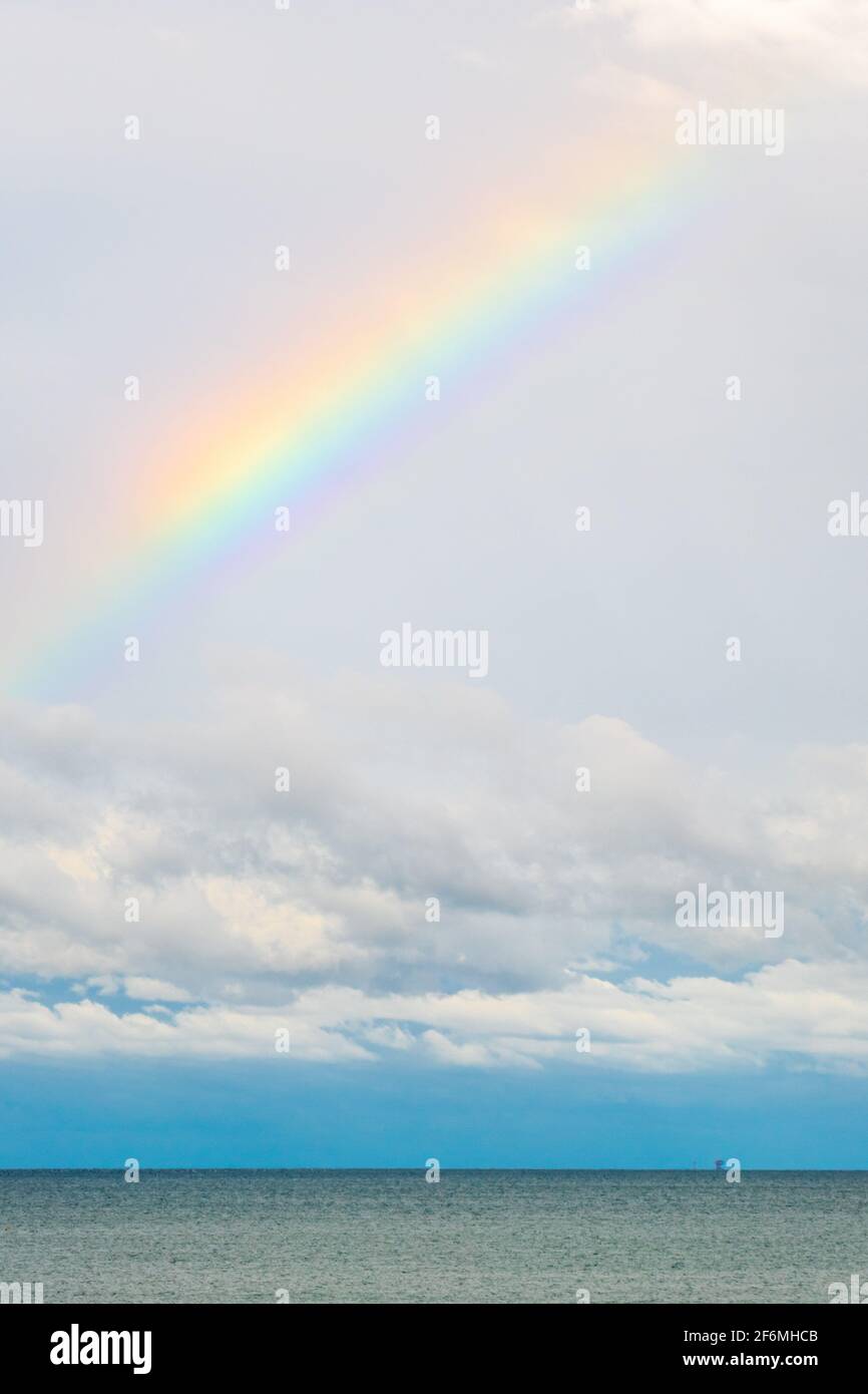 A rainbow in the sky over the sea after a storm Stock Photo - Alamy
