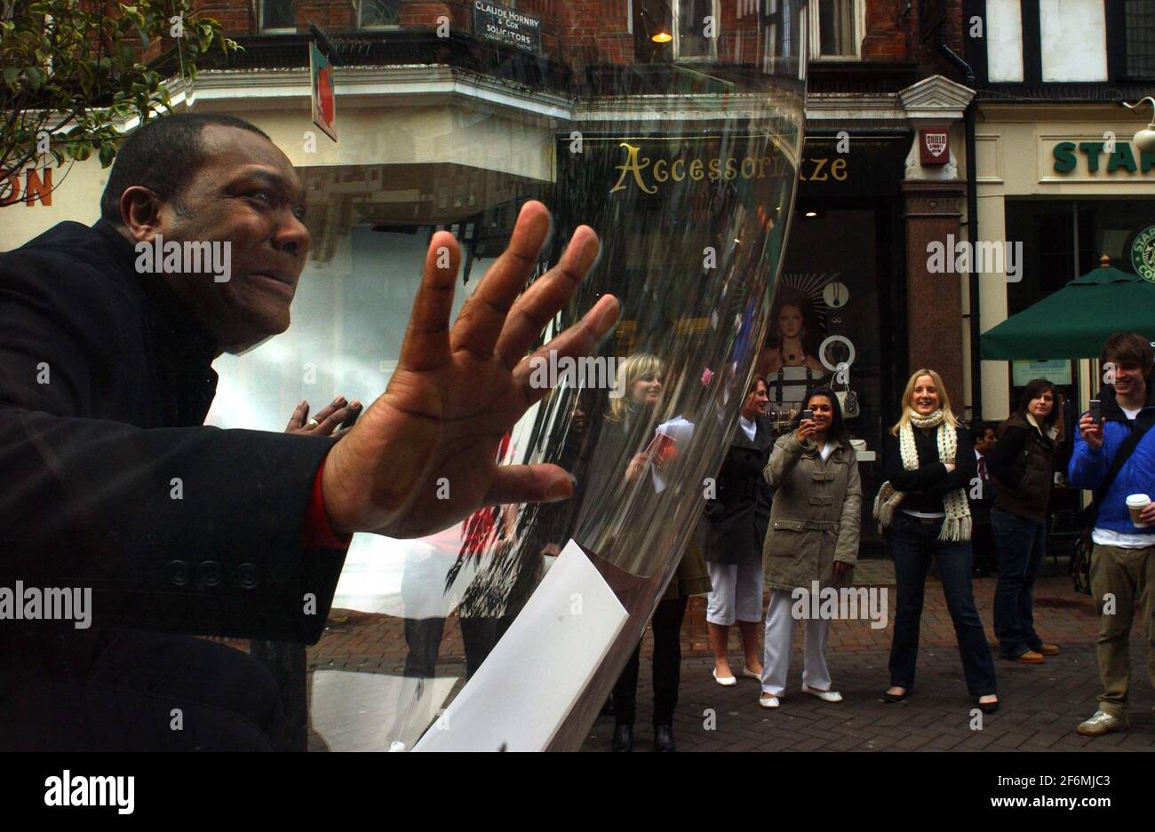 LENNY HENRY TELLS LIGHT BULB JOKES FROM A NEW BOOK, TO PASSERS BY IN CARNABY ST IN AID OF COMIC RELIEF  . 6 March 2007 TOM PILSTON Stock Photo