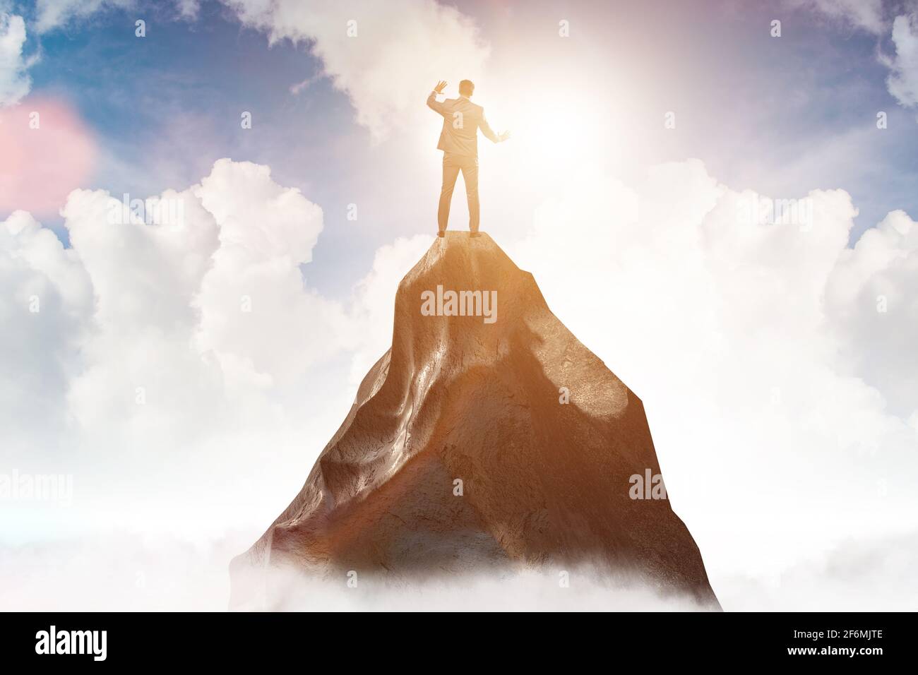 Businessman at the top of mountain in the career concept Stock Photo ...