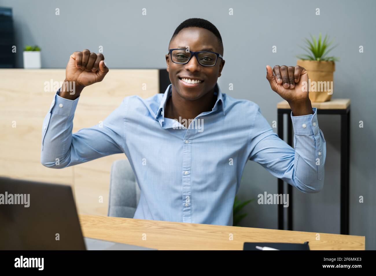 African Black Business Man Celebrating Hands Raised Stock Photo