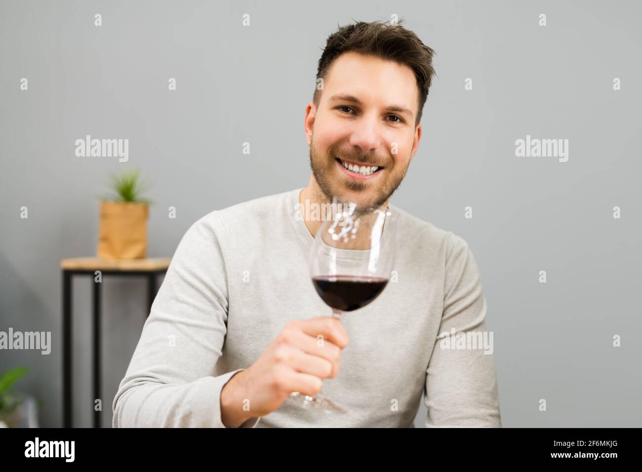 Man Drinking Wine Alcohol In House Room Stock Photo