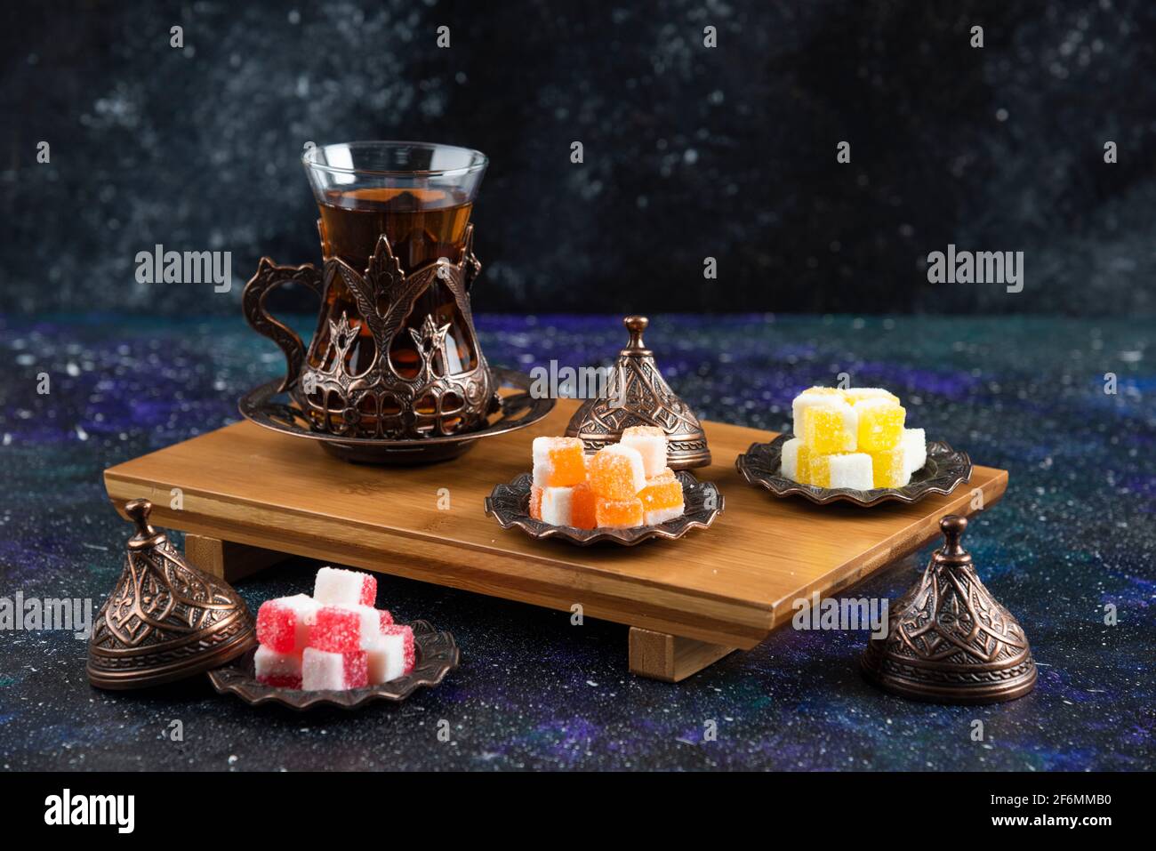Tea set with Turkish delights on wooden board Stock Photo
