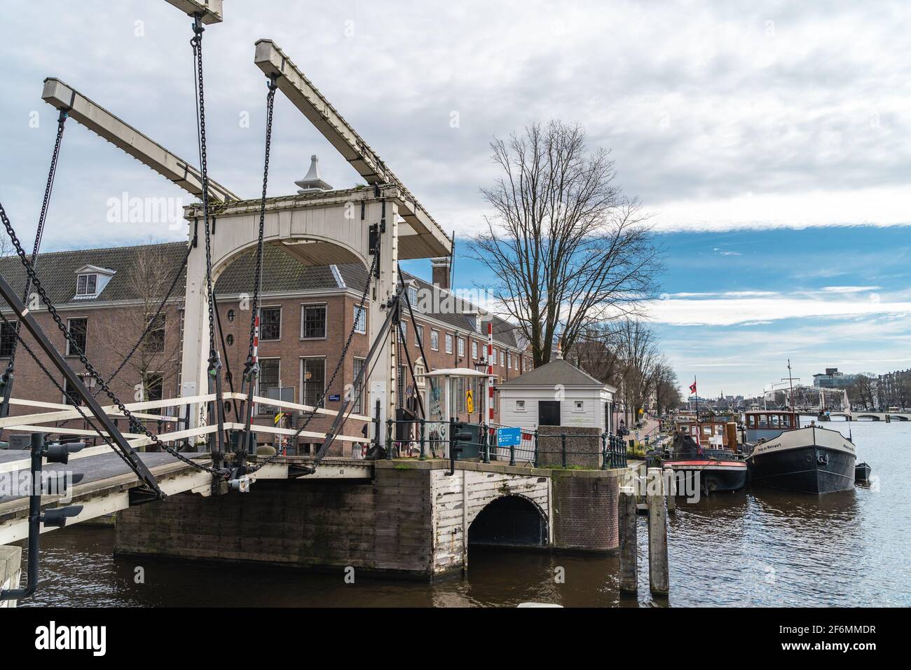 Amsterdam, Netherlands - March 2020: Magere Brug or Skinny Bridge on Amstel river, bascule bridge made of white-painted wood. Stock Photo