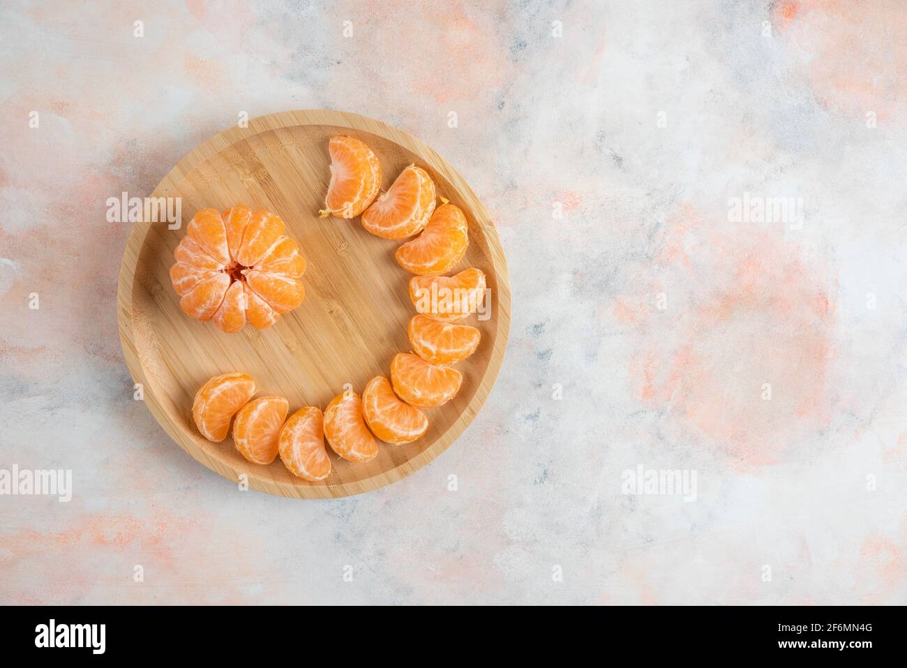 Top view of peeled clementine mandarins over colorful background Stock Photo