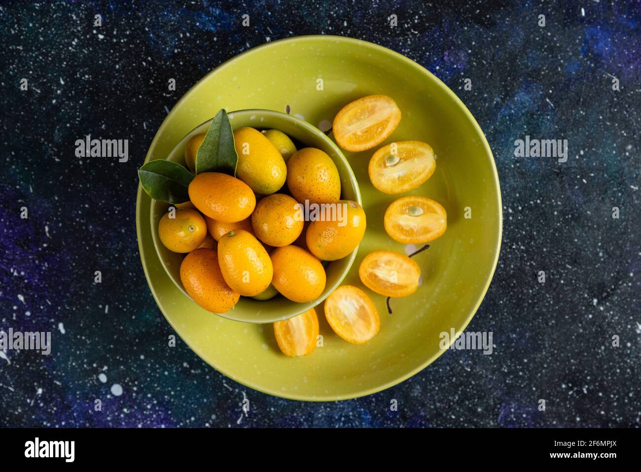 Top view of Fresh organic kumquats whole or half cut Stock Photo