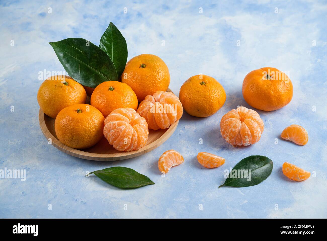 Season fruit. Peeled or whole clementine mandarins Stock Photo