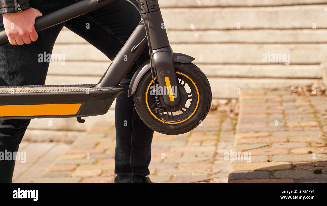 Man carry electric scooter hi-res stock photography and images - Alamy