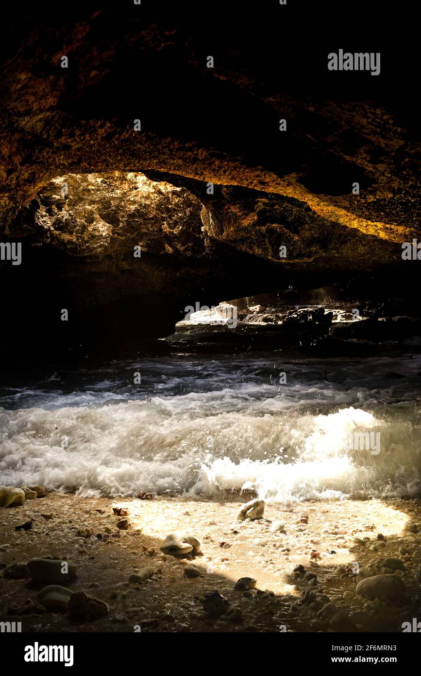 Spectacular Mermaid Caves with sunlight piercing through hole in