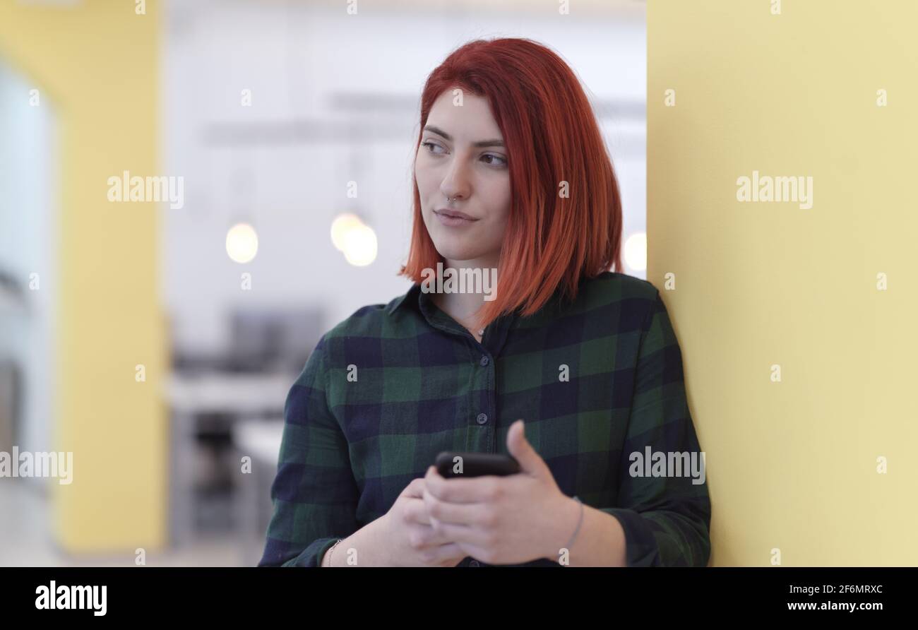 redhead business woman at office using smart phone Stock Photo - Alamy