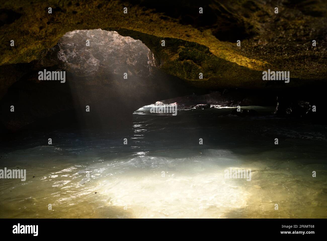 Spectacular Mermaid Caves with sunlight piercing through hole in
