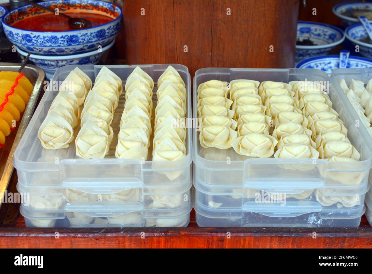 Different types of dumplings ready to be steamed in a street side