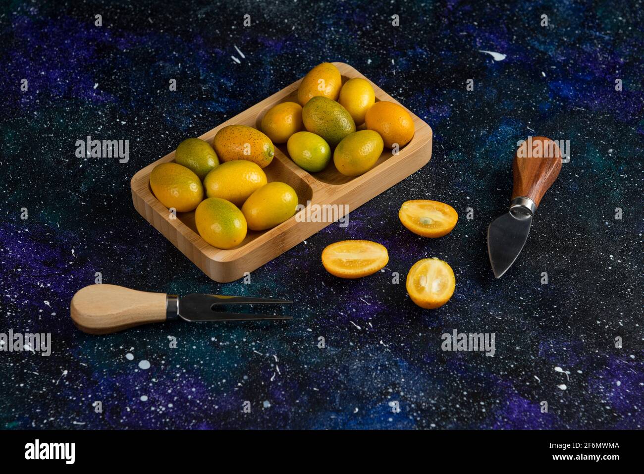 Close up photo of fresh kumquats whole or half cut Stock Photo