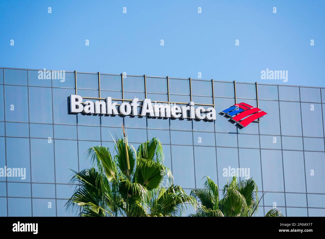 Bank of America sign and trademark logo on glass facade of BofA