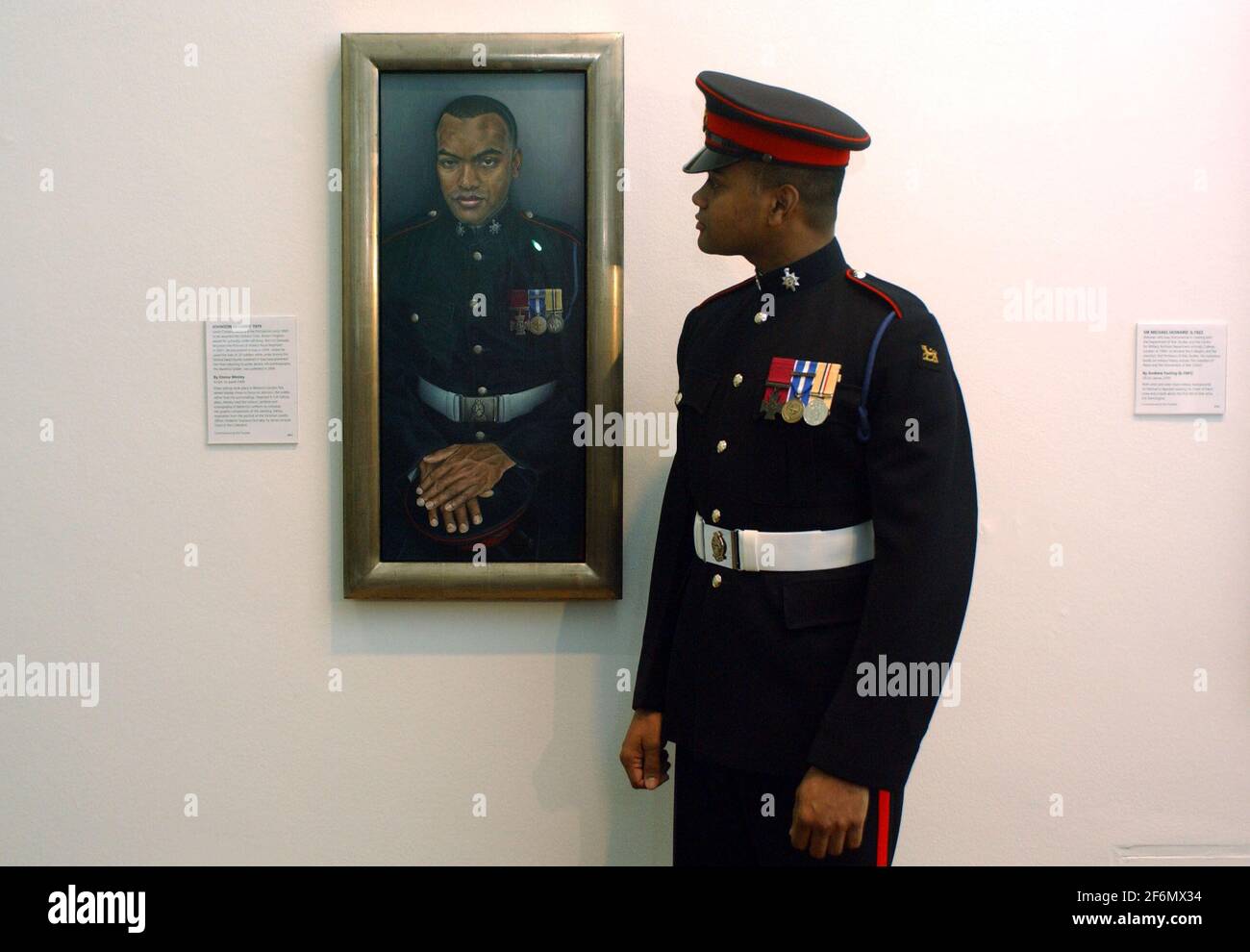 LANCE CORPORAL JOHNSON BEHARRY VC, STANDS BESIDE HIS PORTRAIT IN THE NATIONAL PORTRAIT GALLERY,LONDON.BHARRY WON THE VC FOR SAVING A NUMBER OF COMRADES,TWICE,UNDER INTENSE FIRE IN SOUTHERN IRAQ.THE PAINTING IS BY EMMA WESLEY. 21/2/07 ,TOM PILSTON Stock Photo