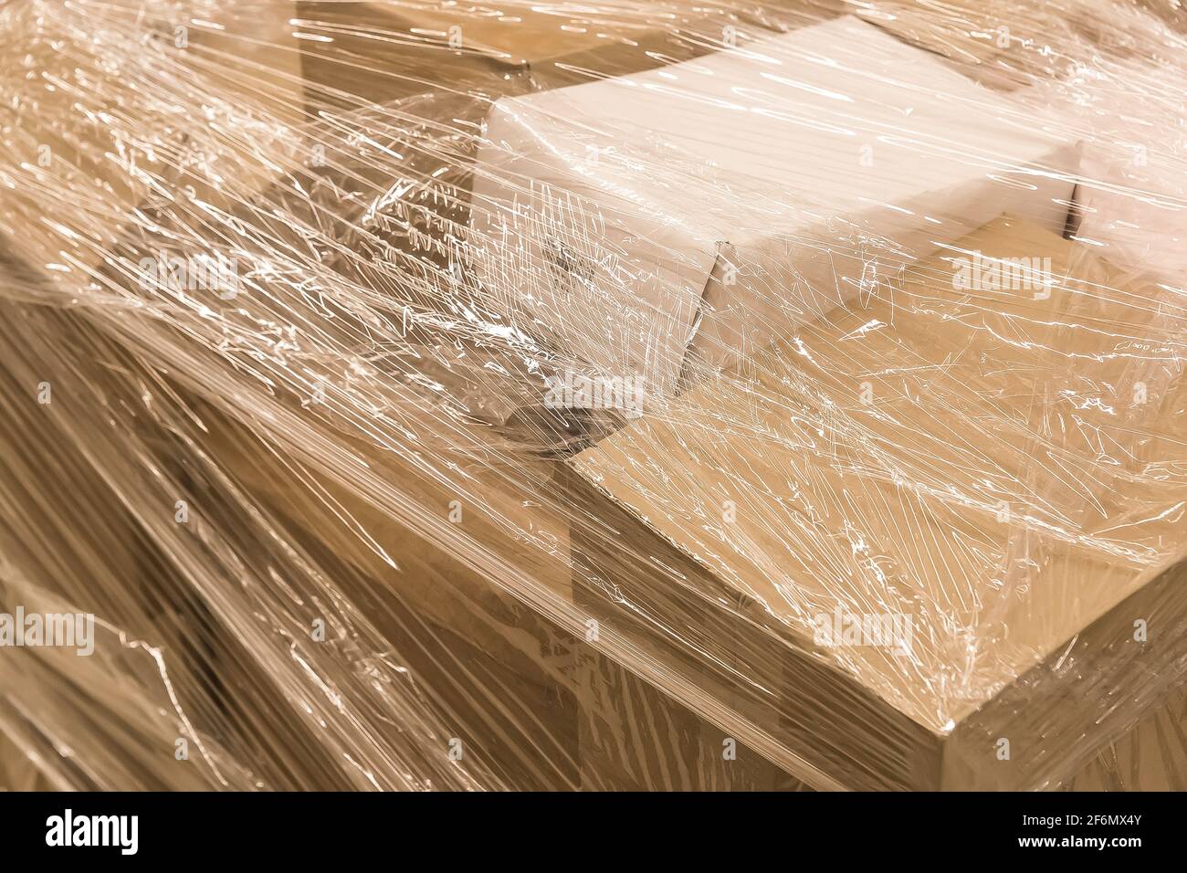 Cardboard boxes with goods or building materials and wrapped in