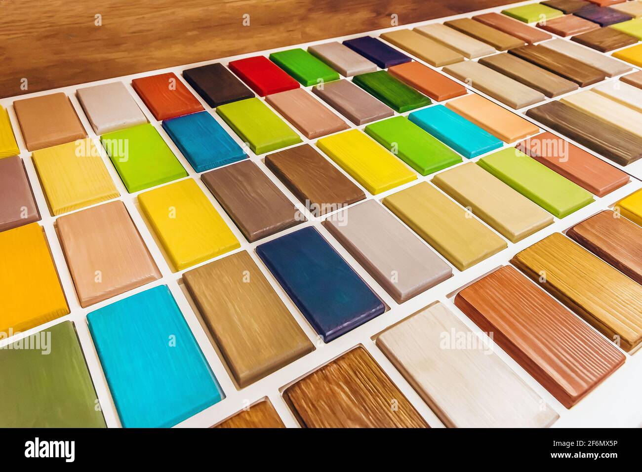 Color samples of paint for wood bars interior design material in a hardware store. Stock Photo