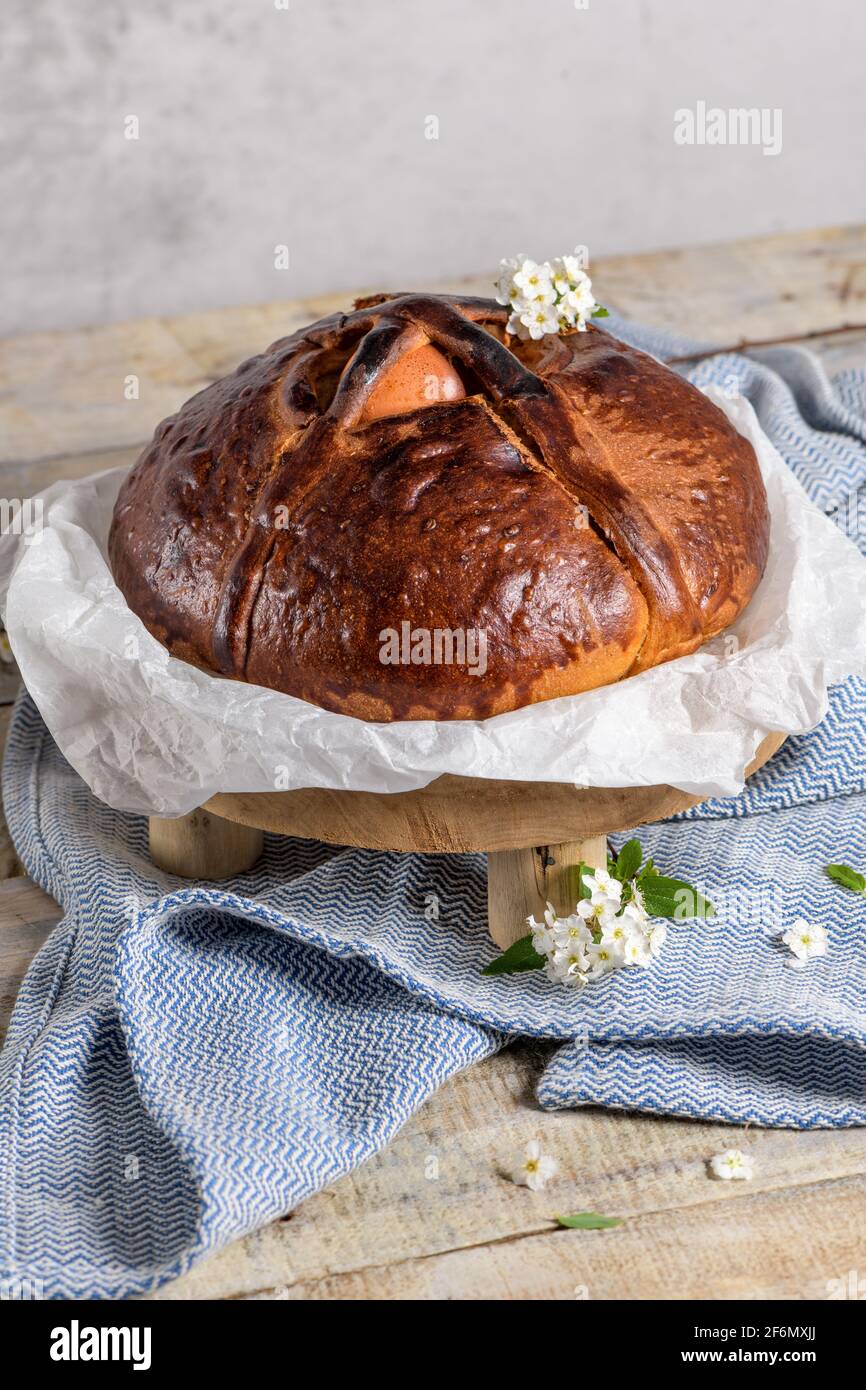 Portuguese traditional Easter cake. Folar with eggs on easter table. Colorful painted eggs. Stock Photo