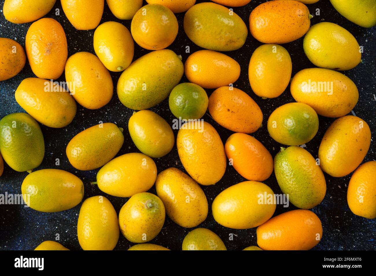 Top view. Pile of kumquats over blue background Stock Photo
