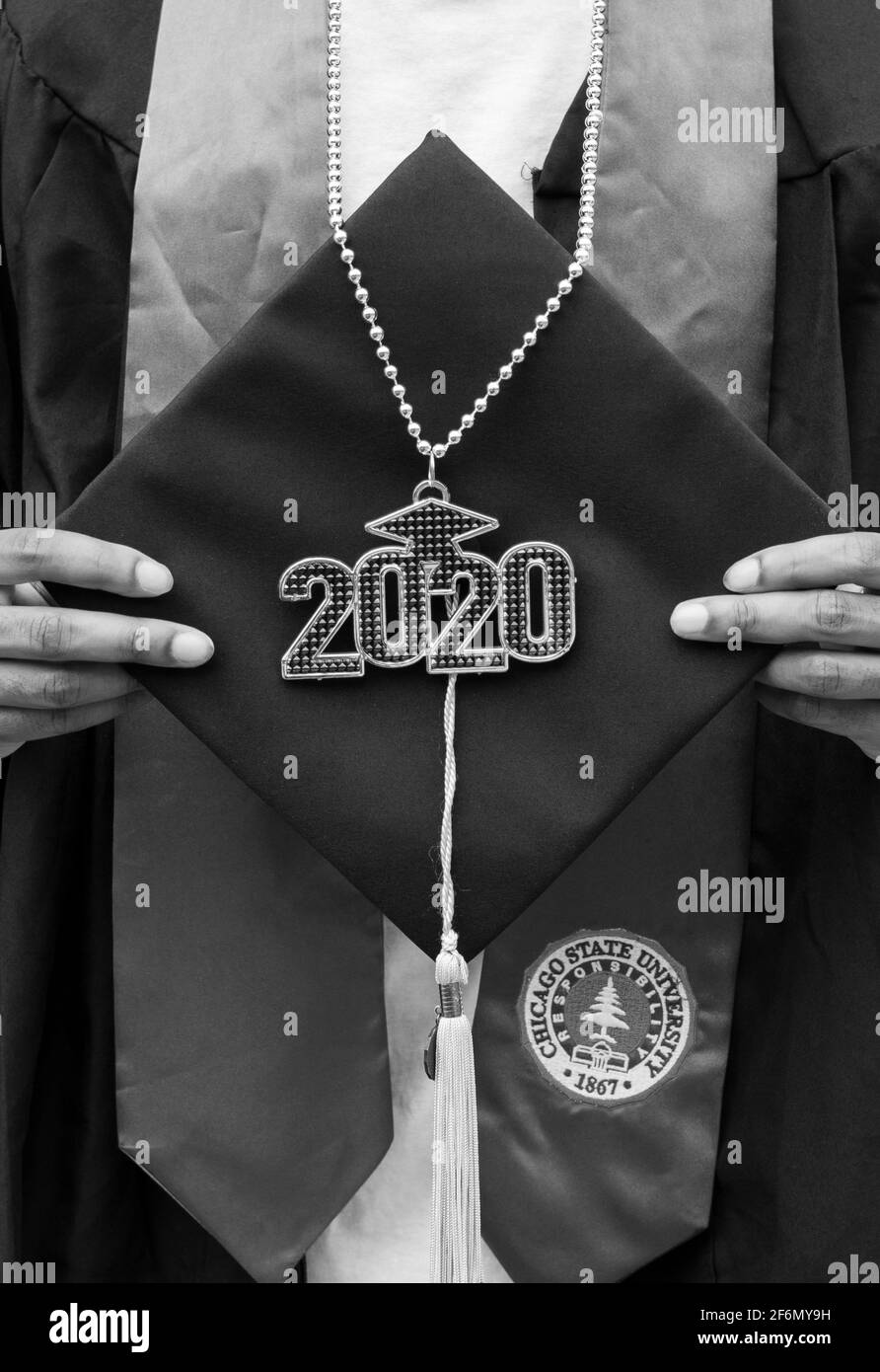 CHICAGO, ILL. USA MAY 20, 2020: DURING THE HEIGHT OF COVID-19 A YOUNG BLACK MALE POSES FOR A PHOTO DURING HIS DRIVE BY COLLEGE GRADUATION CELEBRATION Stock Photo