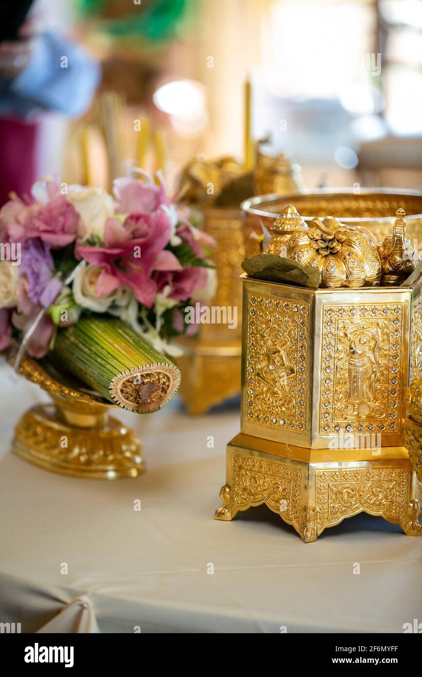 Flowers and gold ornament containers for a Cambodian wedding ceremony Stock Photo