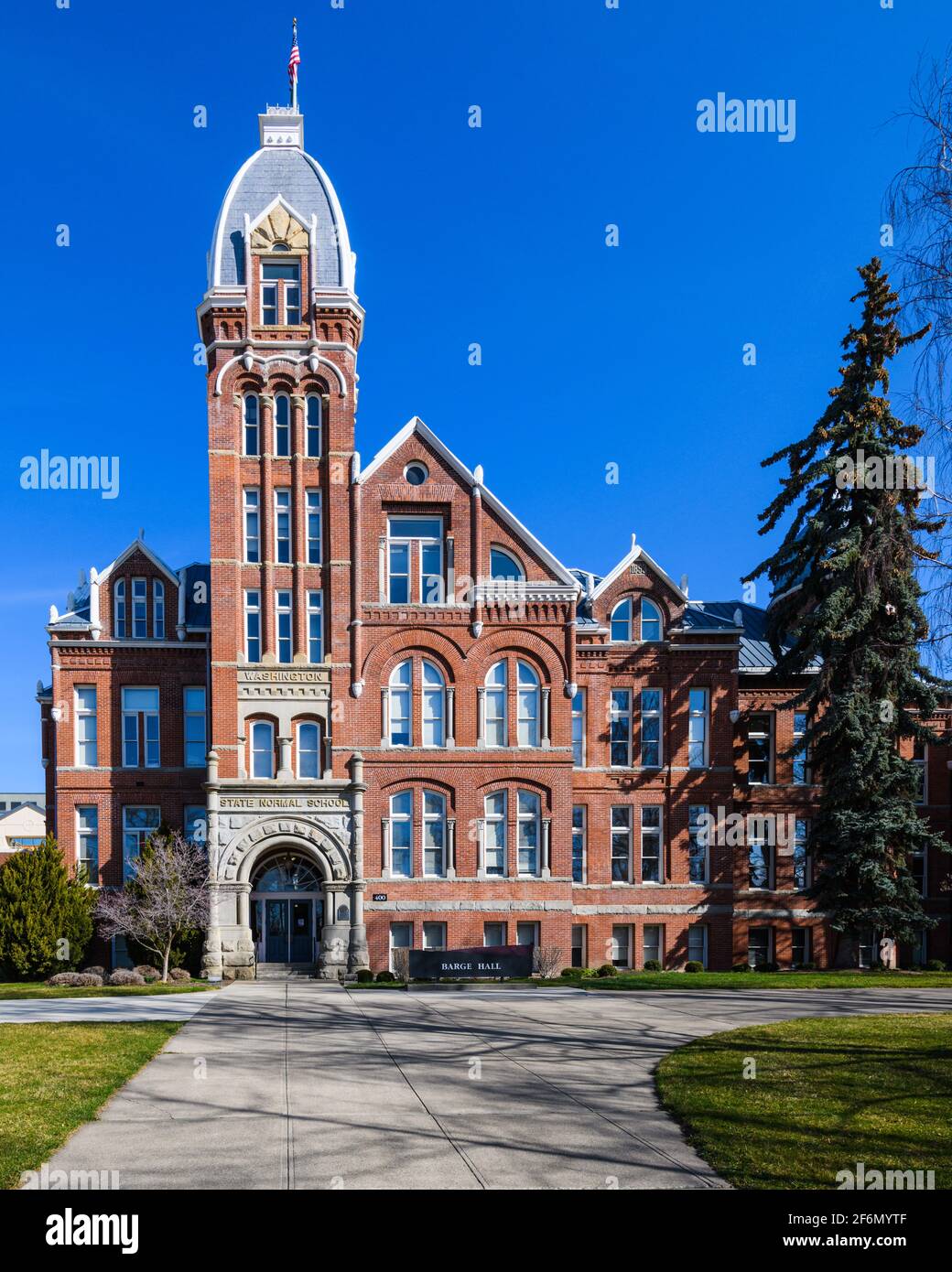 The Romanesque styled Barge Hall under a perfect blue sky at Central Washington University in Ellensburg with no people due to covid-19 restrictions Stock Photo