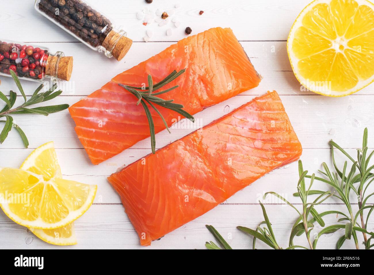 Salmon fillet, red salted fish on a white table. Lemon, rosemary spices Copy space. Stock Photo