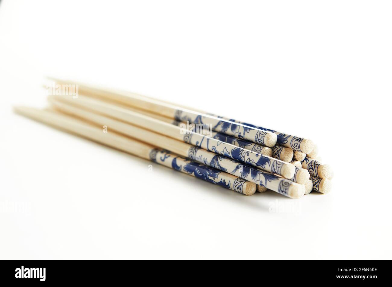 Wooden chopsticks with stacked stack pattern isolated on white background. Stock Photo