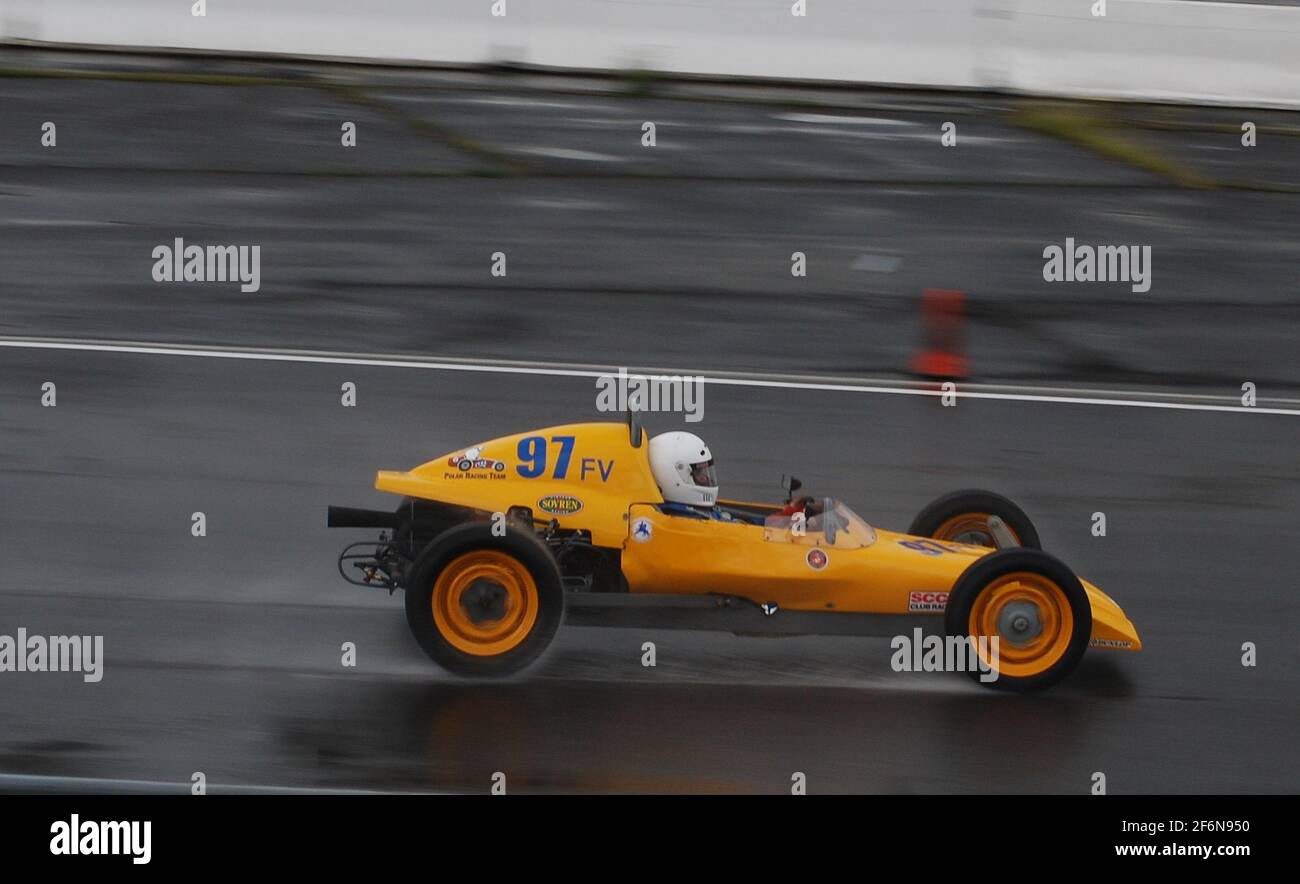 A 1968 Lynx FV formula race car accelerates down the track at a vintage