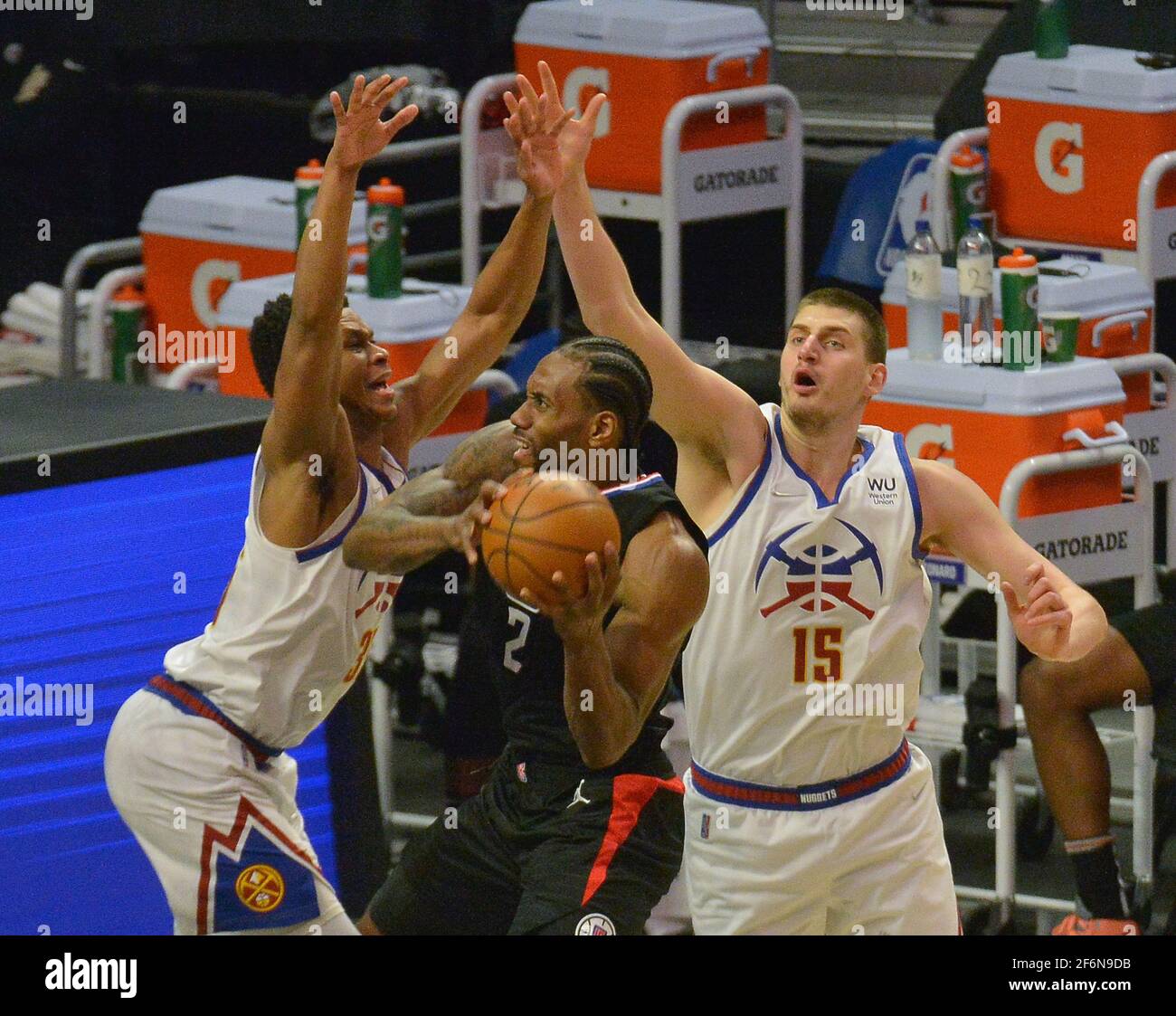 Los Angeles, United States. 18th Jan, 2021. Los Angeles Clippers' forward Terrance  Mann is double teamed by Indiana Pacers' center Goga Bitadzen and guard  Cassius Stanley in the paint during the fourth
