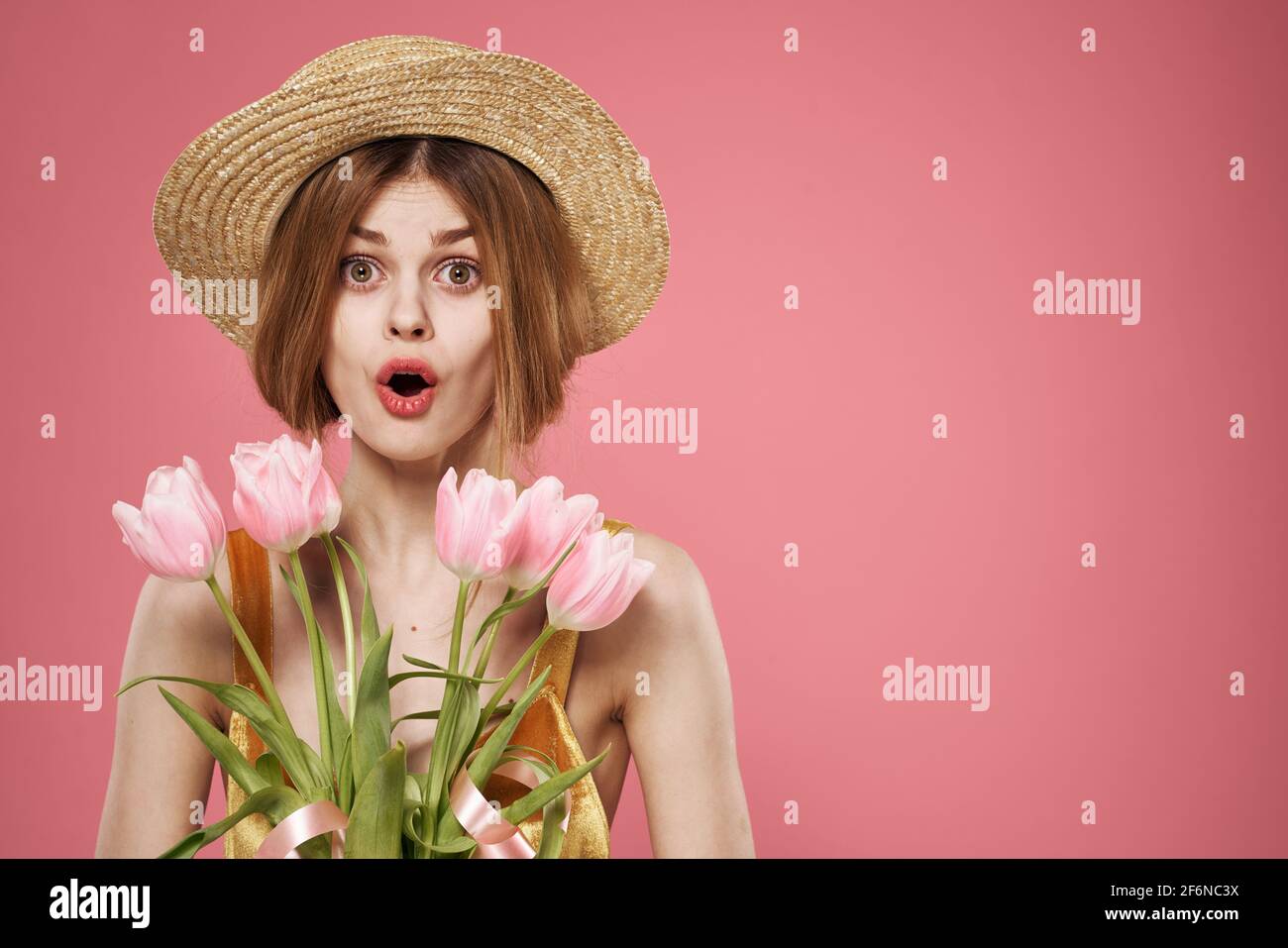 Pretty woman in hat bouquet flowers holiday gift pink background Stock ...