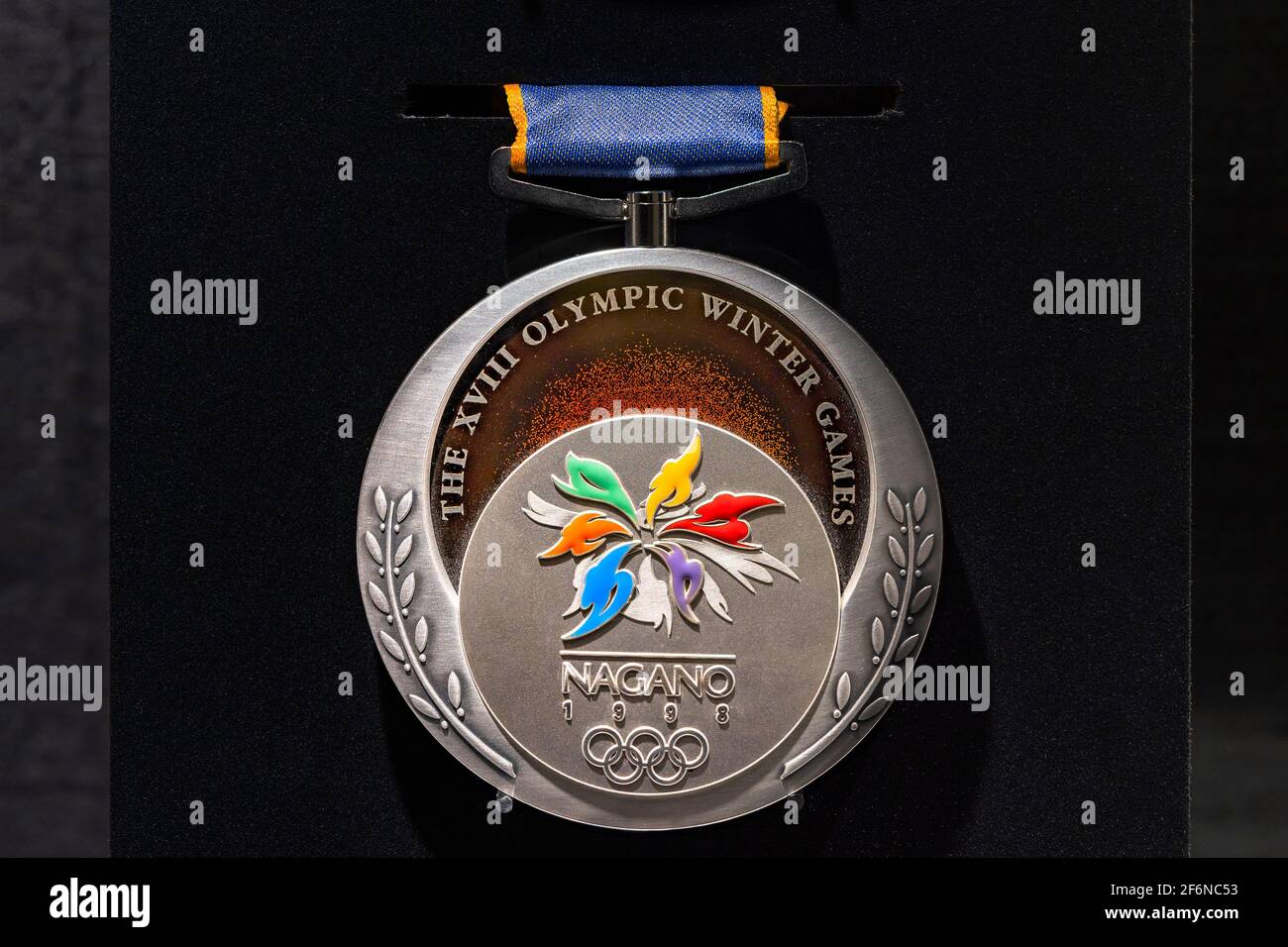 tokyo, japan - march 2 2021: Close up on the official silver medal used during the 1998 Winter Olympics of Nagano exhibited in the Japan Olympic Museu Stock Photo