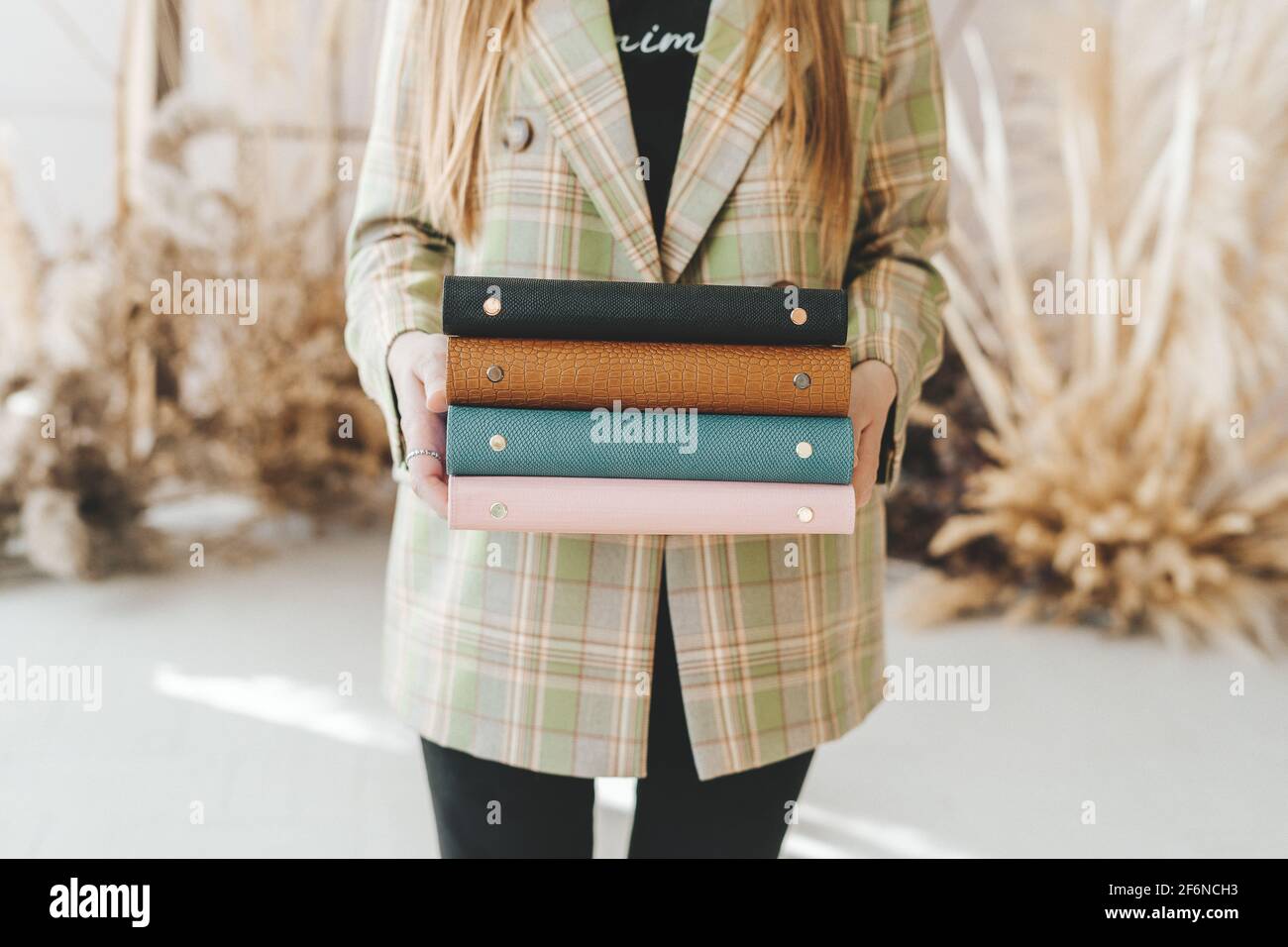 Business woman with stack of notebooks Stock Photo