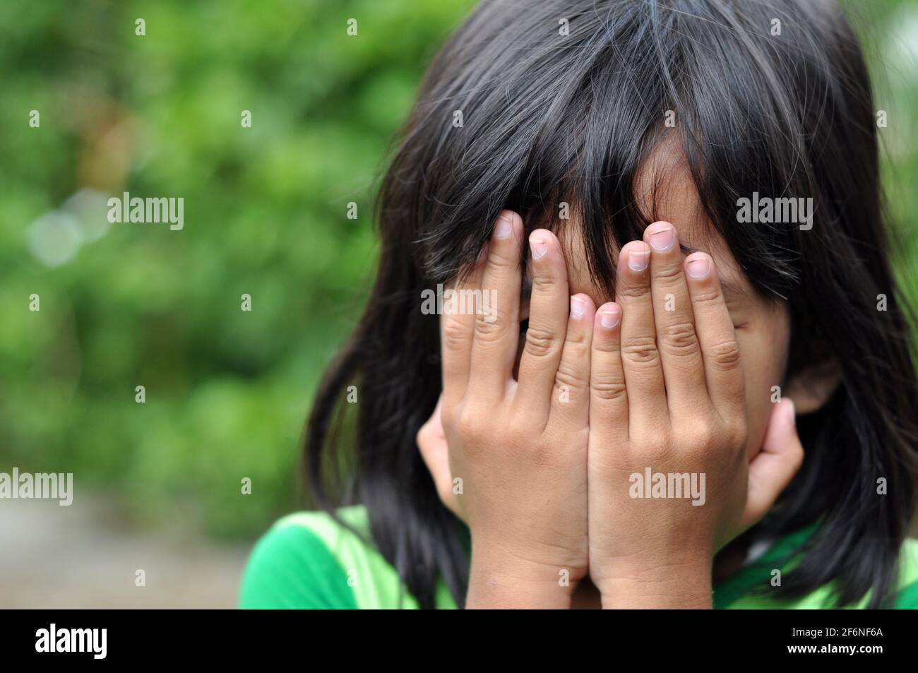 Girls cover their faces with their hands Stock Photo Alamy
