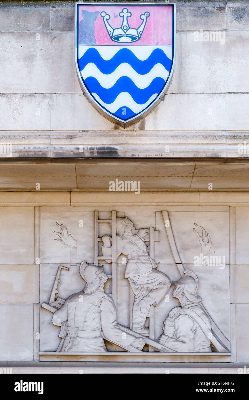 Stone relief sculpture by Gilbert Bayes on the Lambeth Fire Brigade Building (1937), former HQ of the LFB, at Albert Embankment in London. Stock Photo