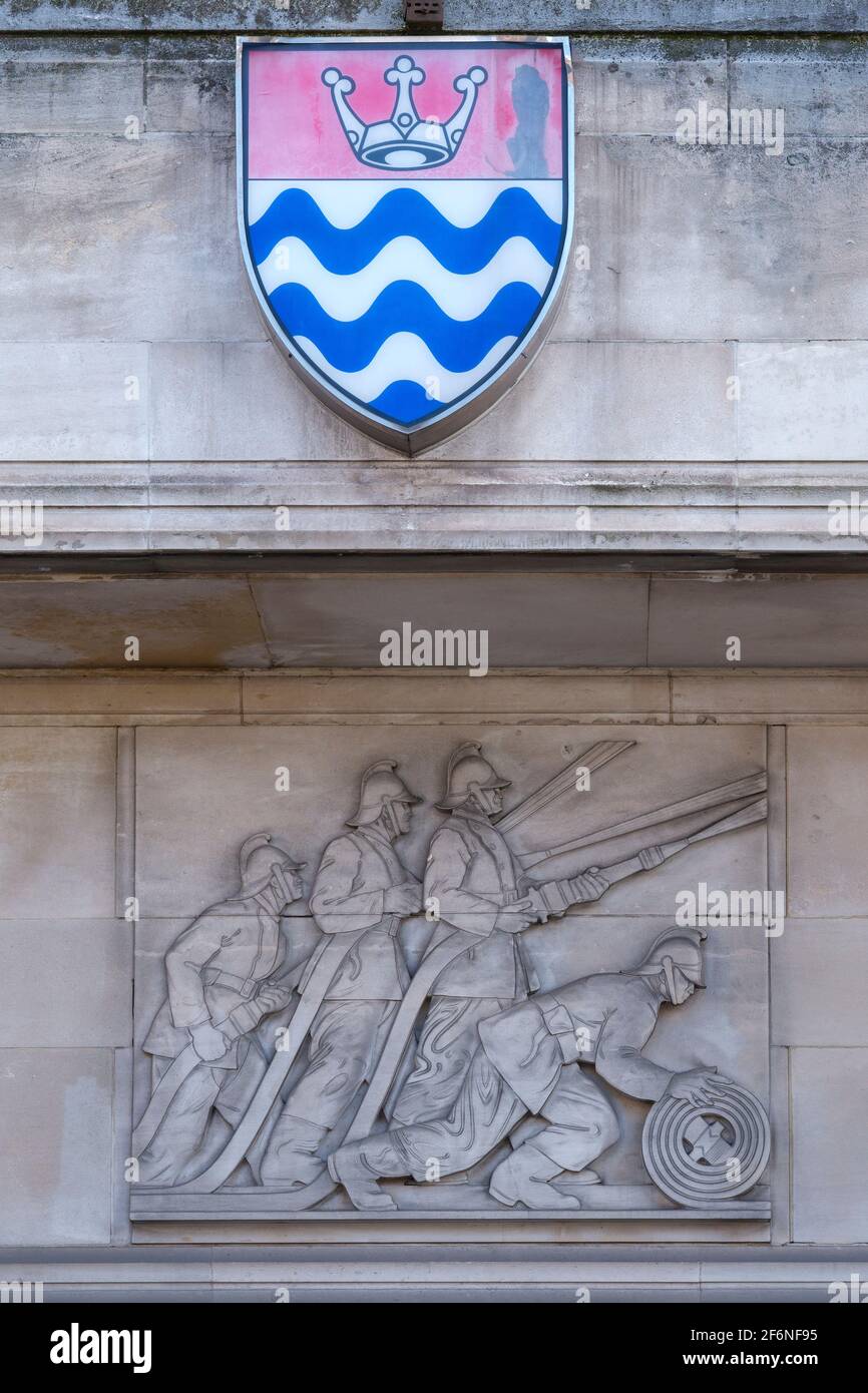 Stone relief sculpture by Gilbert Bayes on the Lambeth Fire Brigade Building (1937), former HQ of the LFB, at Albert Embankment in London. Stock Photo