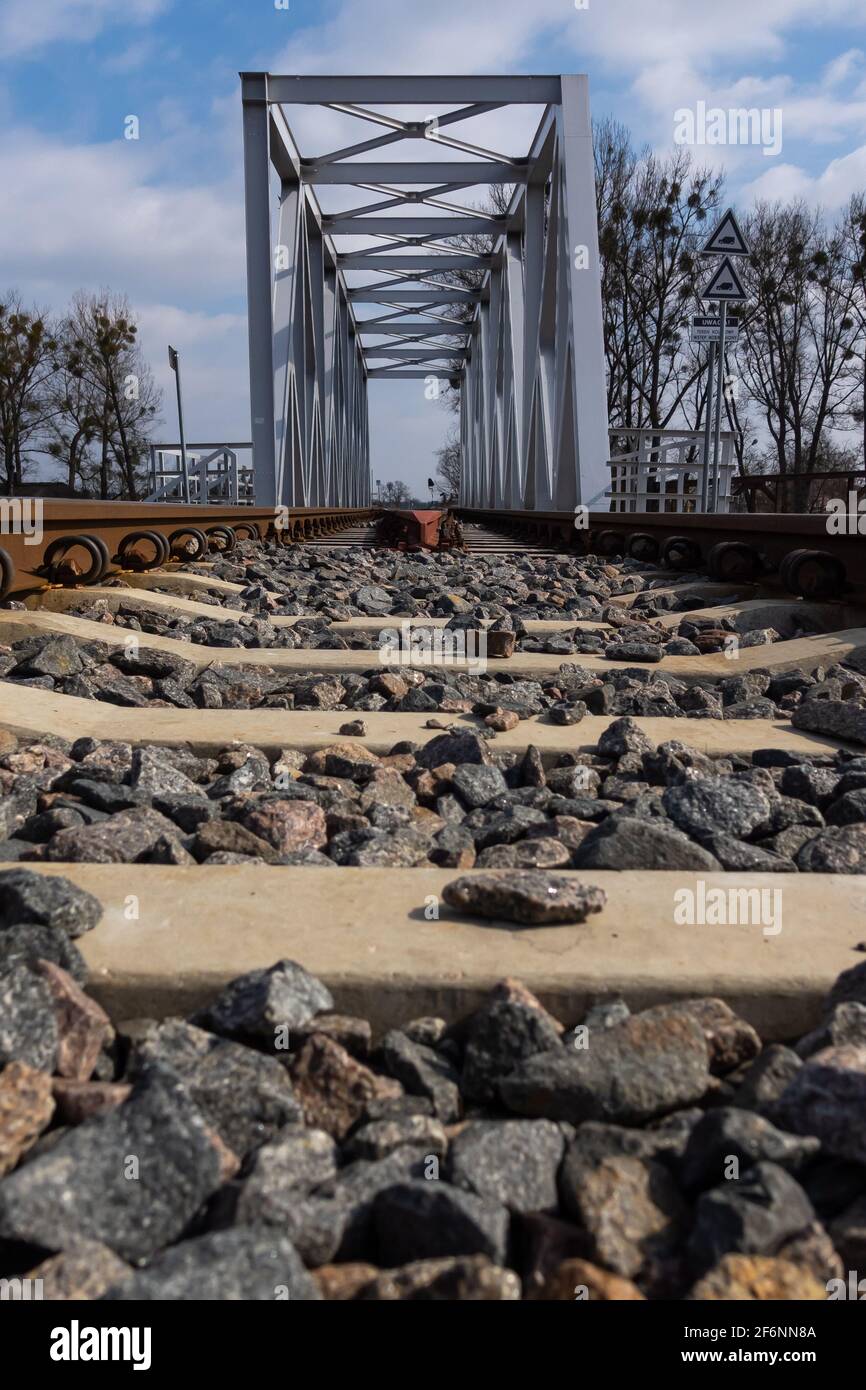 Train Bridge Railing A close-up on rails and a railway bridge. Perspective photo taken on a ...