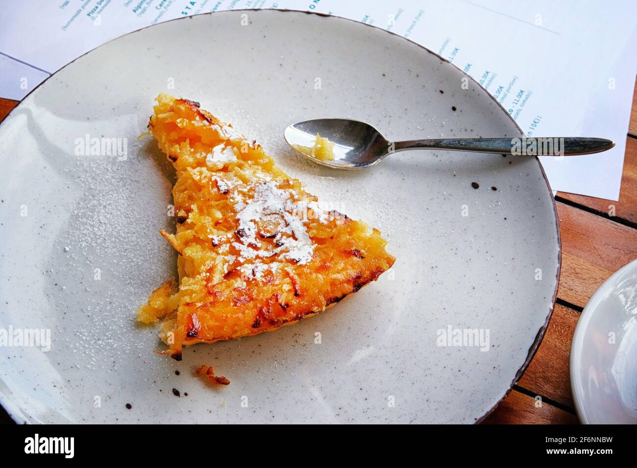 Slice of freshly baked apple open pie on porcelain plate, closeup Stock Photo