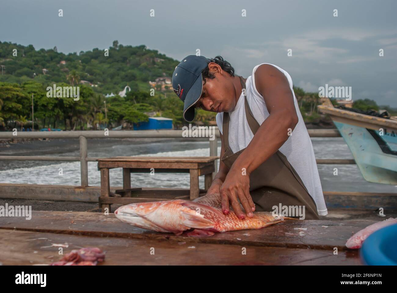 La Libertad, El Salvador. 11182019. Young male fisherman is cleaning