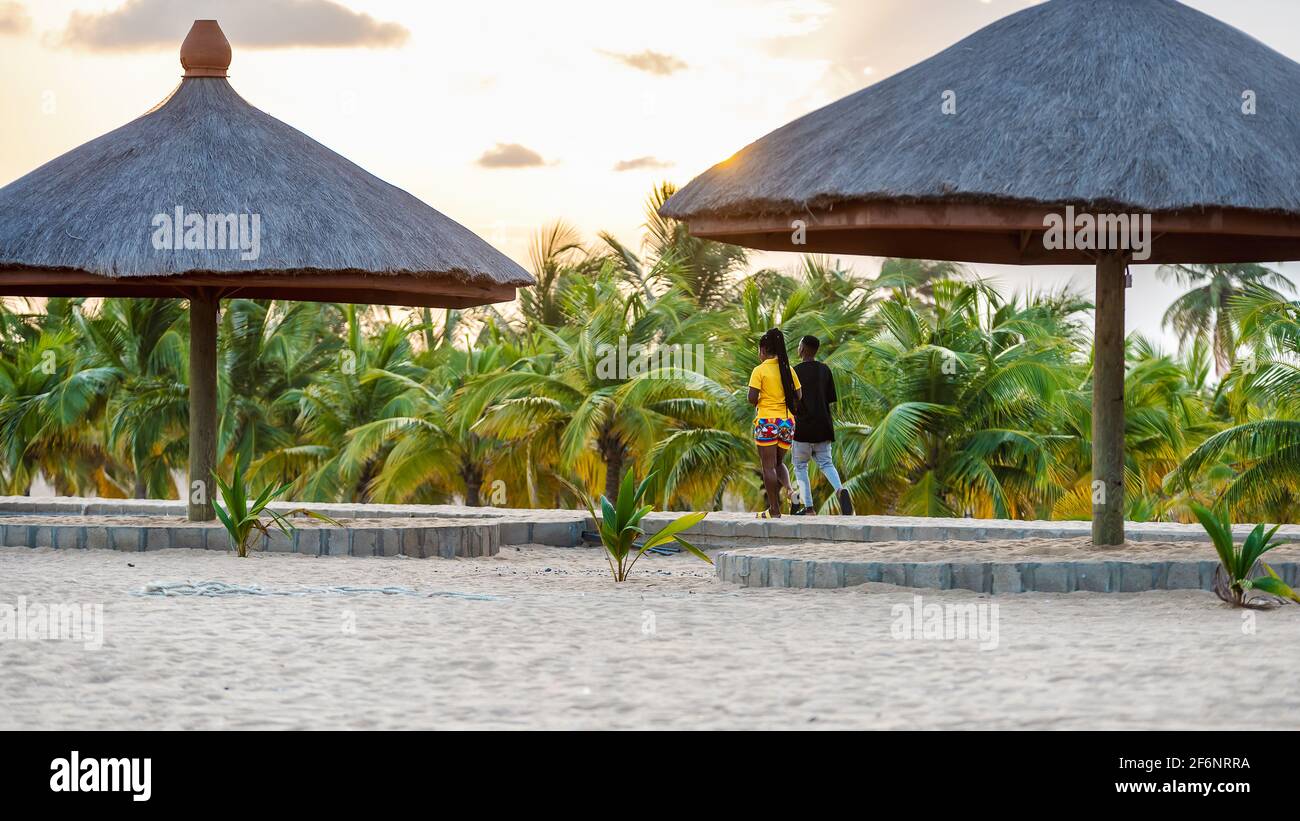 Young african couple walking on walking beach road at sunset in Keta Ghana West Africa, 2020 November 11 Stock Photo