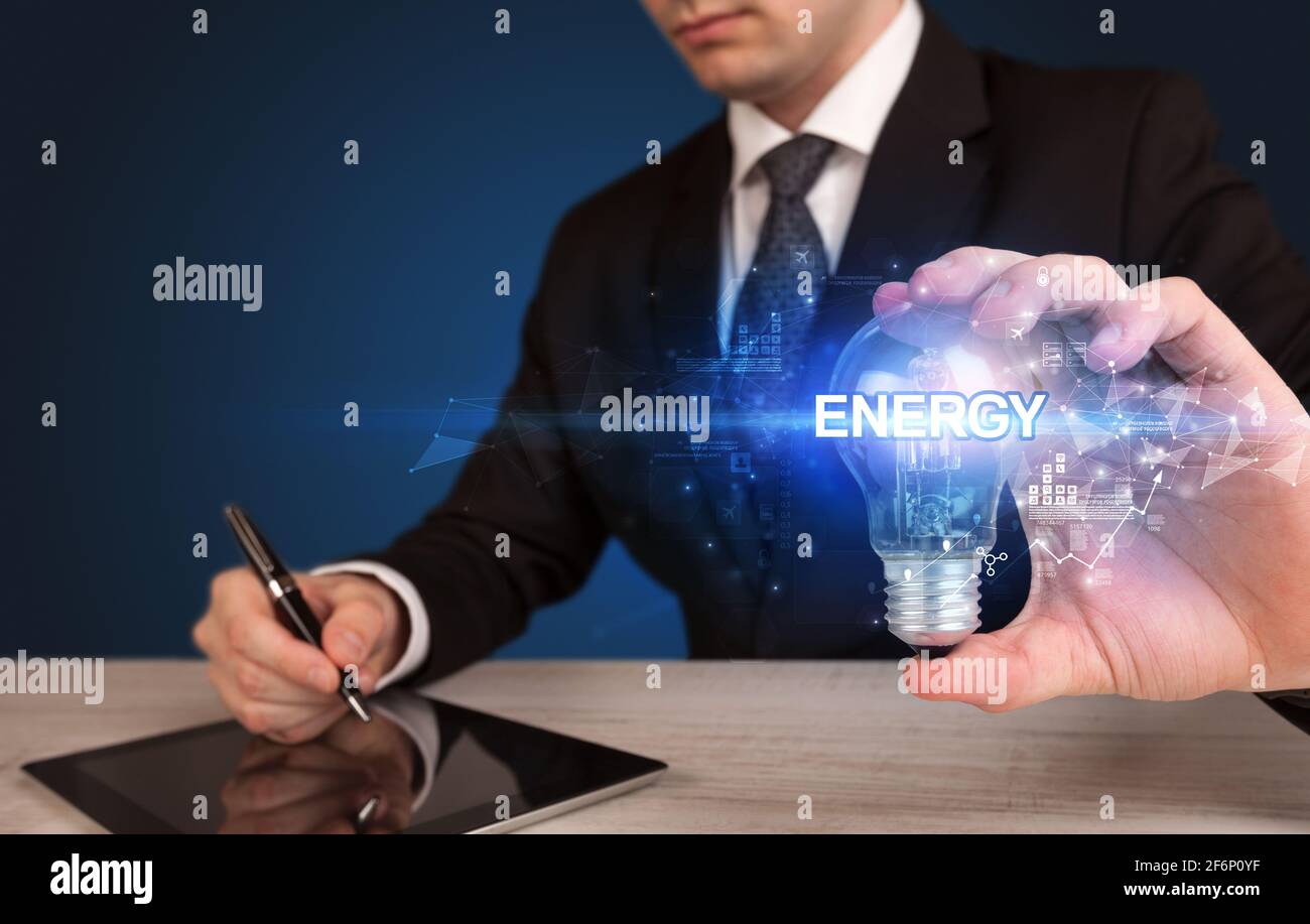 Businessman holding a light bulb Stock Photo - Alamy