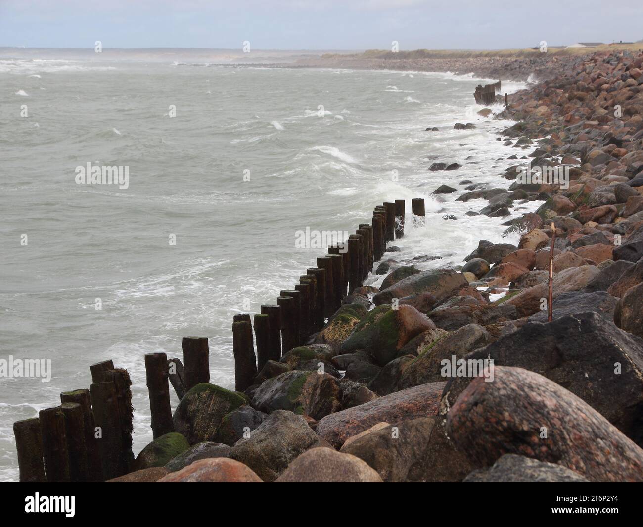 Coastline of Denmark with Silent Water and breakwater Rocks Stock Photo