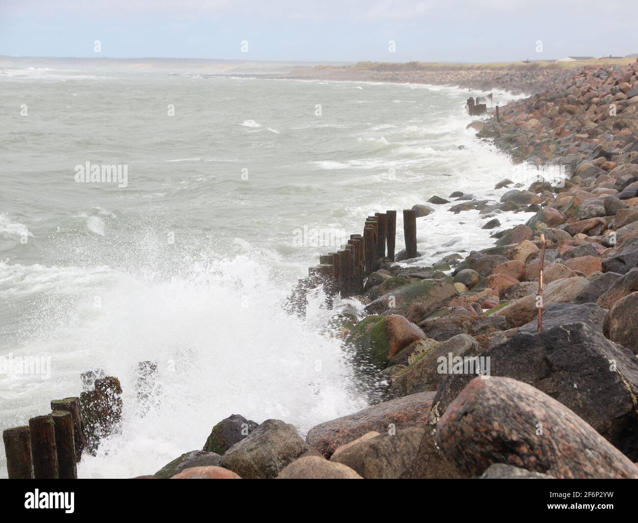 Crashing fierce waves against black rocks at coast Stock Photo