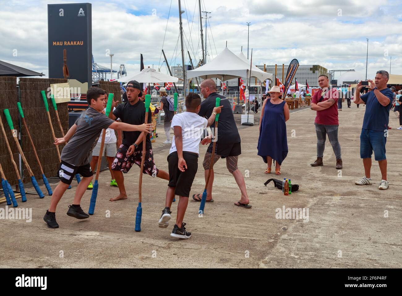 Mau rakau, a Maori martial art / game of skill being practiced in Auckland, New Zealand. The men try to grab the poles before they hit the ground Stock Photo
